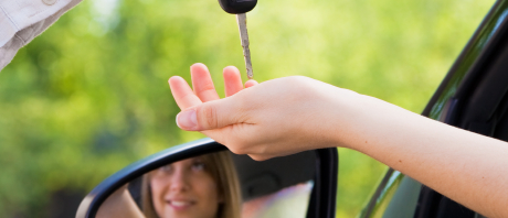 Car key exchange through side mirror reflection.